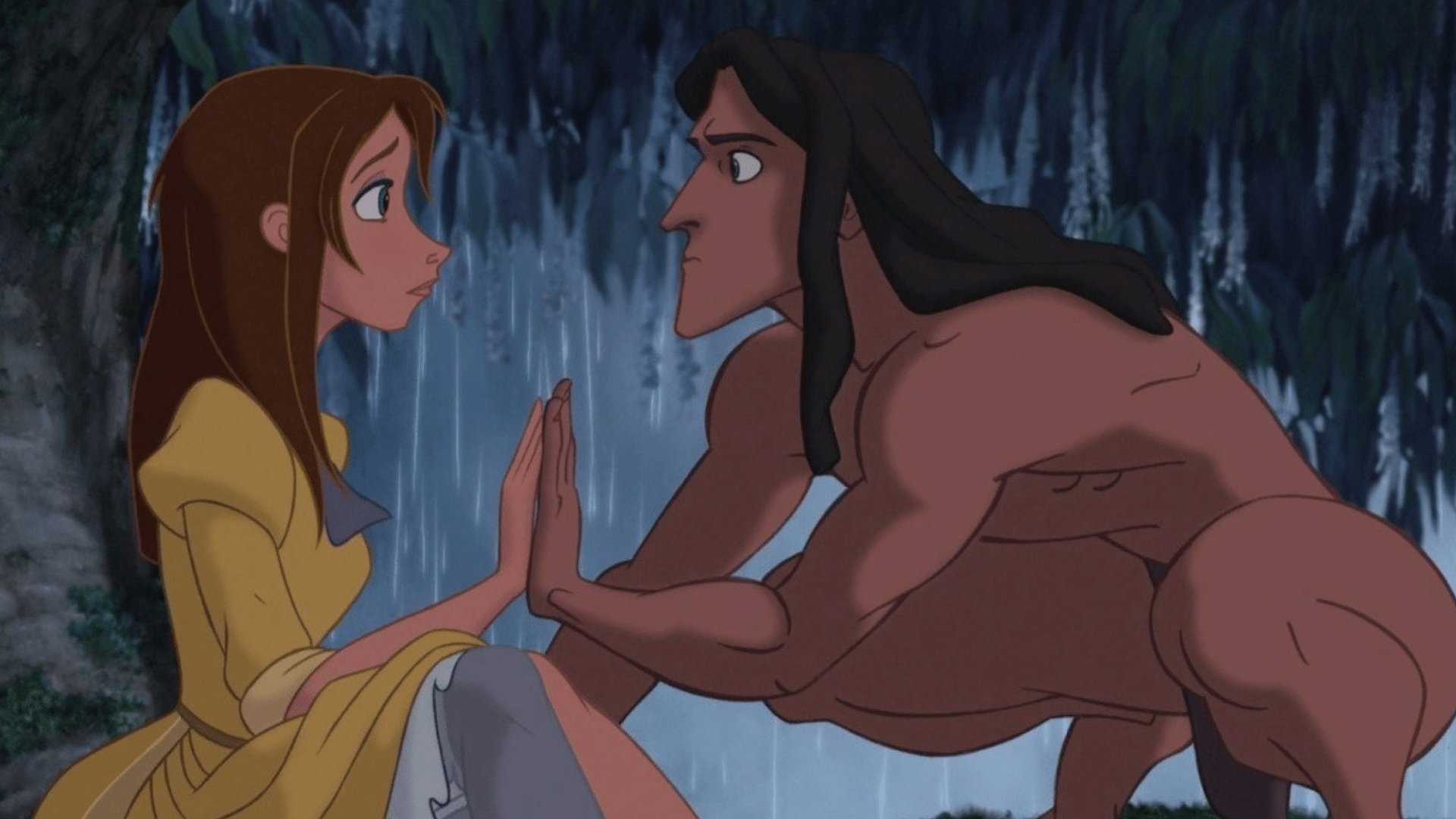 Tarzan e Jane olhando um para o outro enquanto estão com as palmas das mãos encostadas