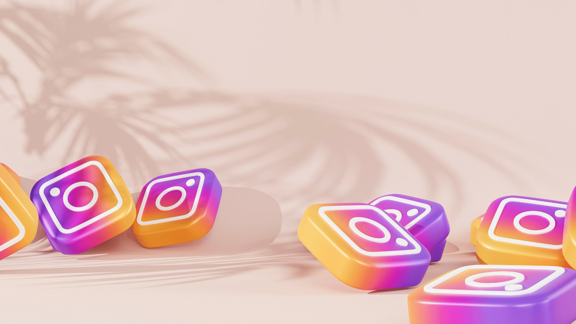Vários ícones do aplicativo instagram espalhados em uma superfície rosa