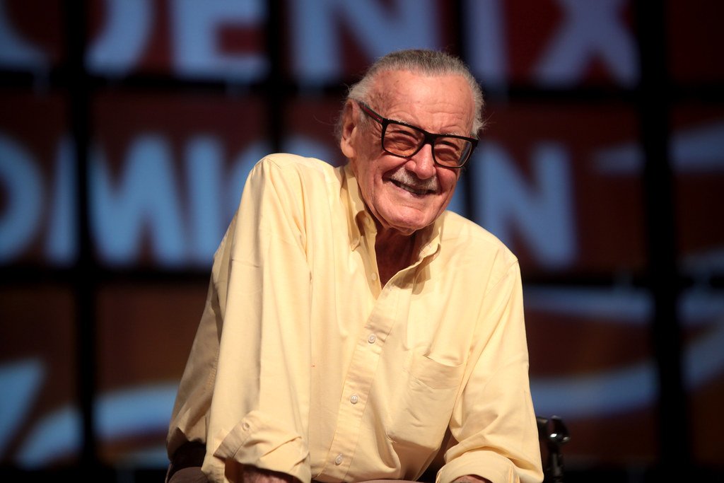 Stan Lee sorridente em palco de evento Comicon