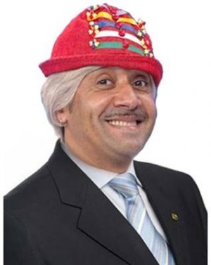 Foto de Tiririca com chapéu e roupa social.