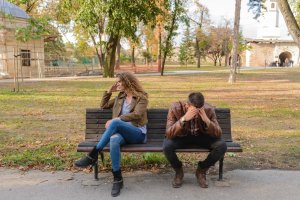 Casal estressado em um parque, brigados um com o outro.