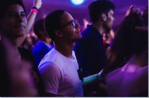 Homem no meio de pessoas em uma balada