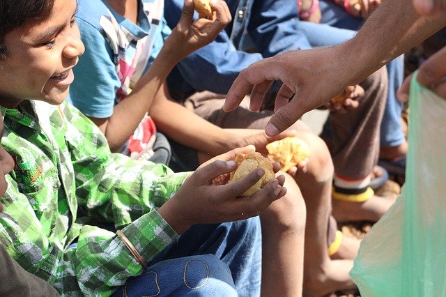 Pessoa entregando comida para uma criança