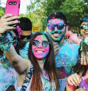 Grupo de amigos com tinta no rosto tirando foto