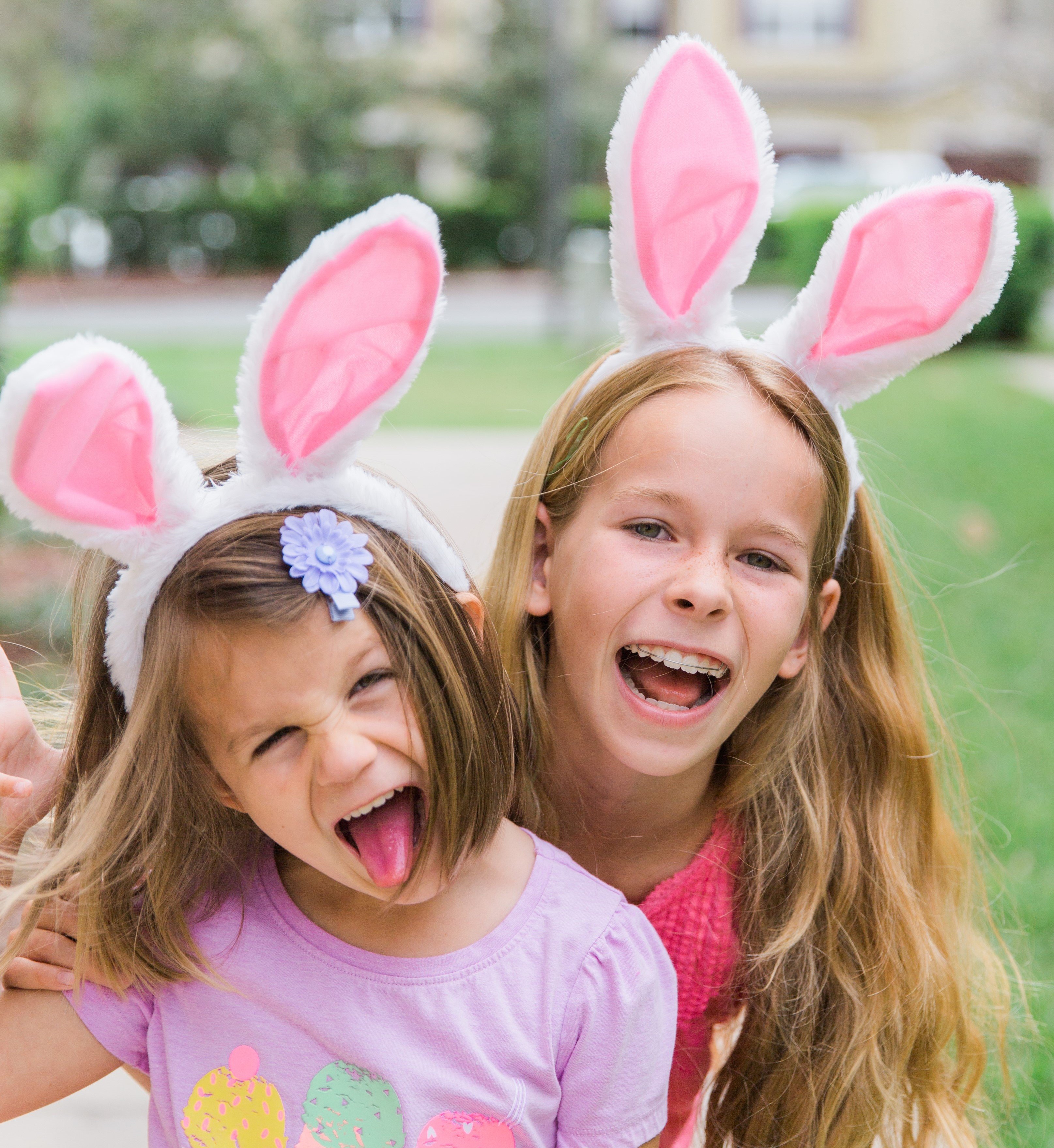 Duas meninas sorrindo com orelhas de coelho