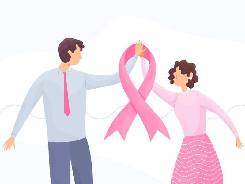 Homem e mulher segurando uma faixa rosa de prevenção ao câncer de mama.