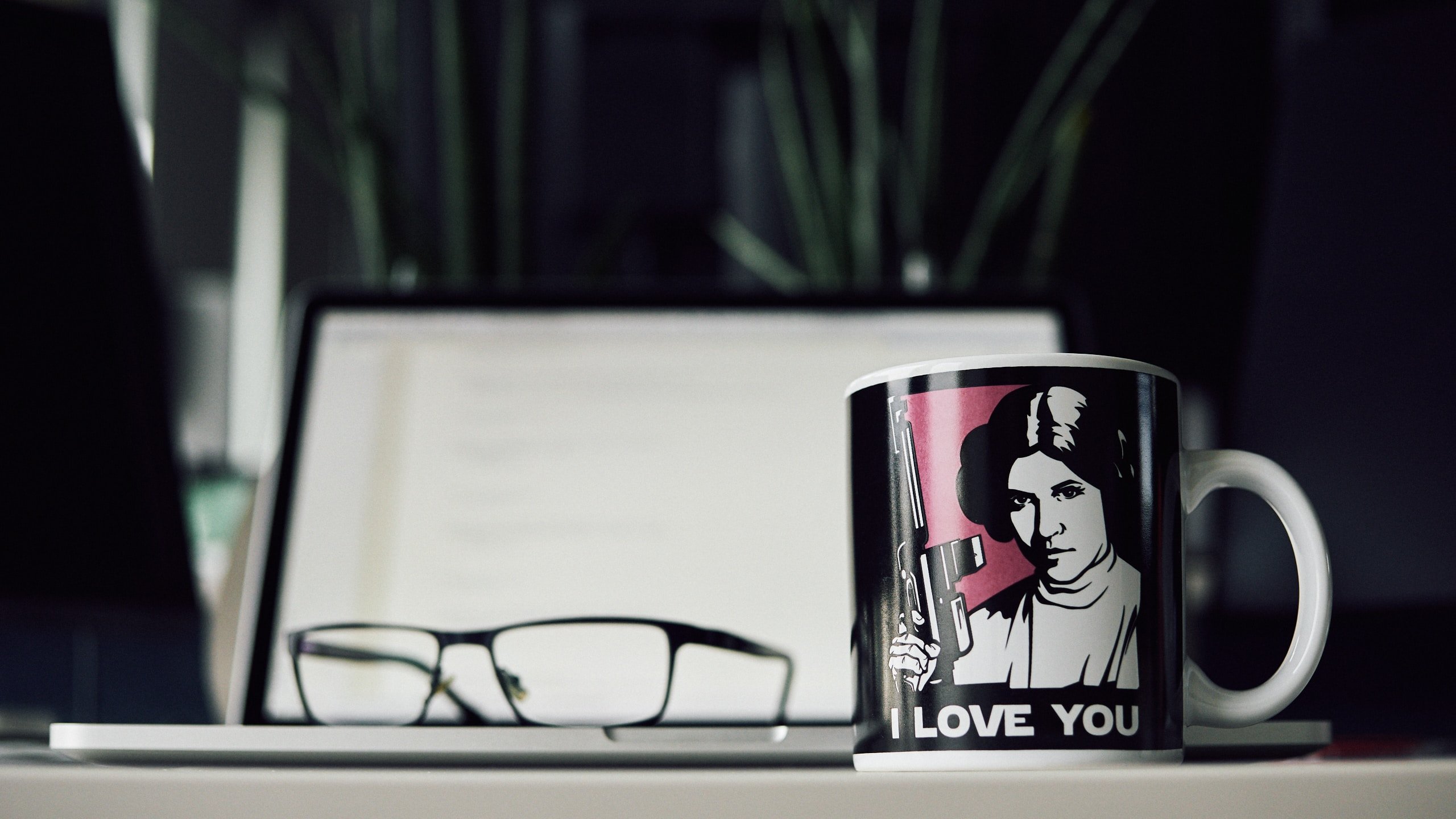 Caneca da Princesa Leia ao lado de um óculos.