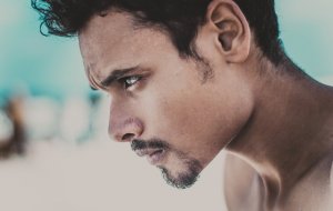 Foto de Mustafa ezz no Pexels Homem de cabeça baixa olhando para frente com raiva.