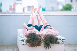 Pixabay/ Jess Foami Casal de meninas deitadas lado a lado em varanda