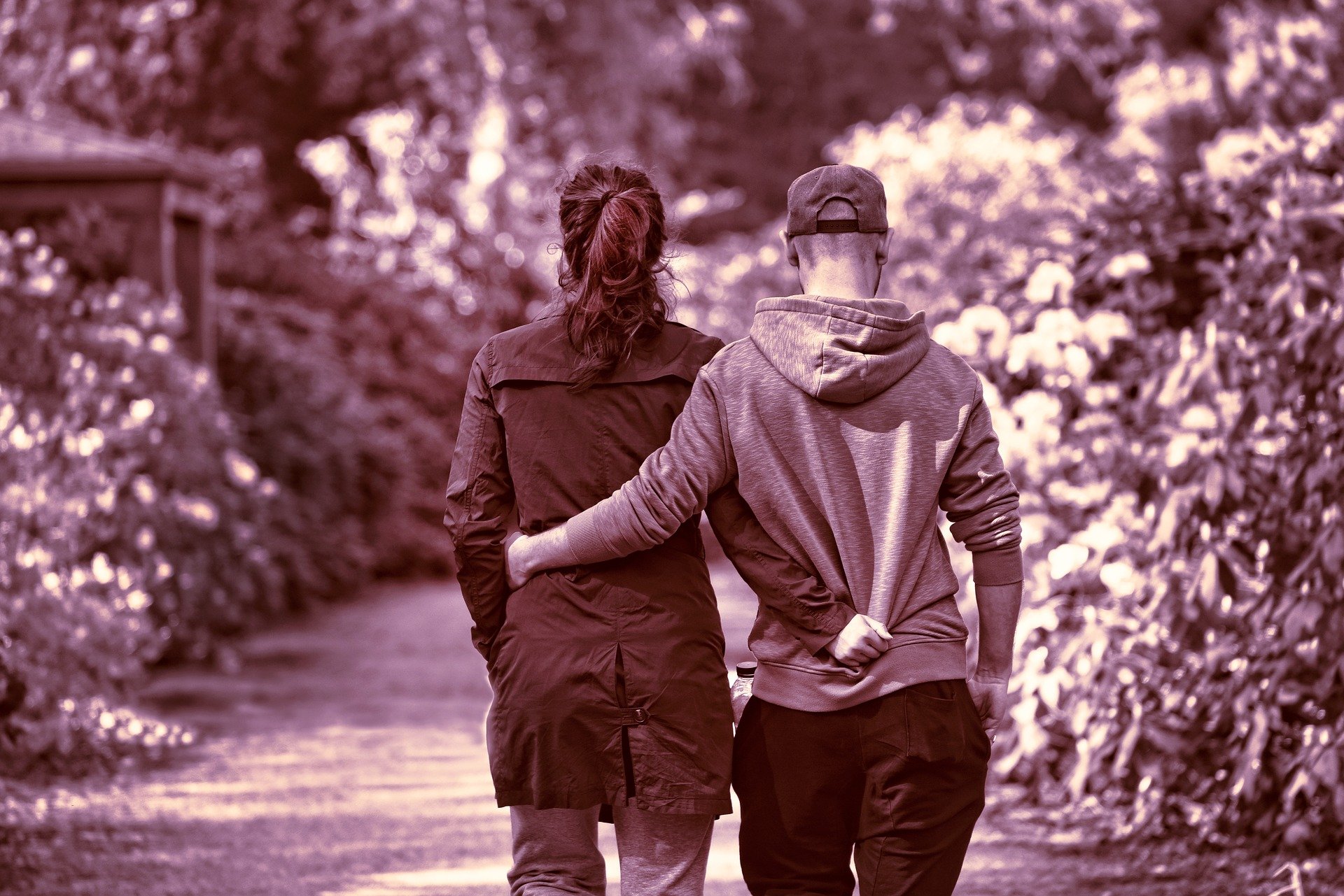 Homem e mulher caminhando juntos em meio a floresta
