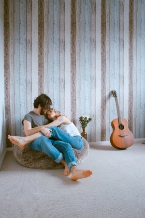 Unsplash Casal se abraçando sentados em puff no chão
