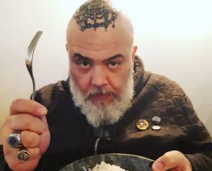 Reprodução/Super rádio tupi João Gordo segurando garfo e prato de comida