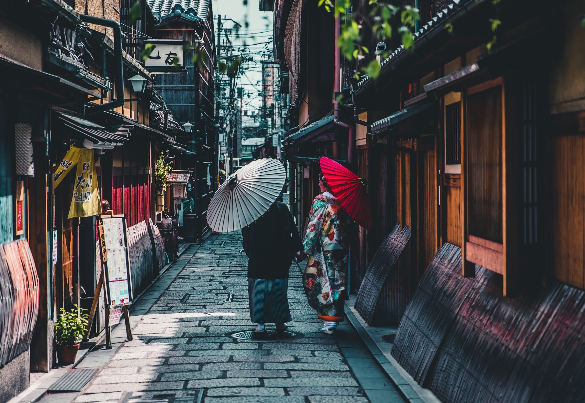 Pessoas caminhando pelas ruas do Japão com guarda-chuvas