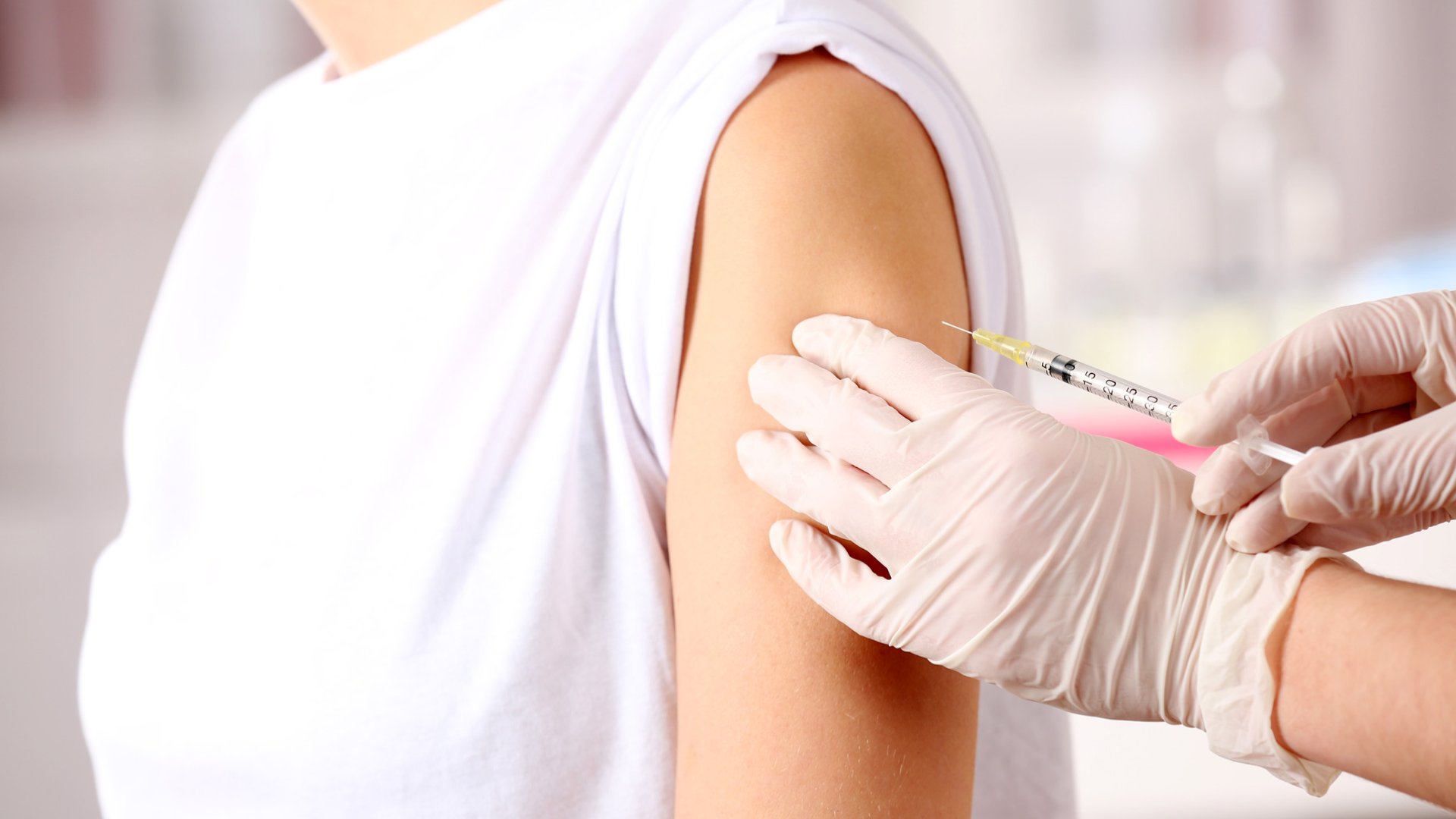 Mulher tendo a vacina aplicada em seu braço