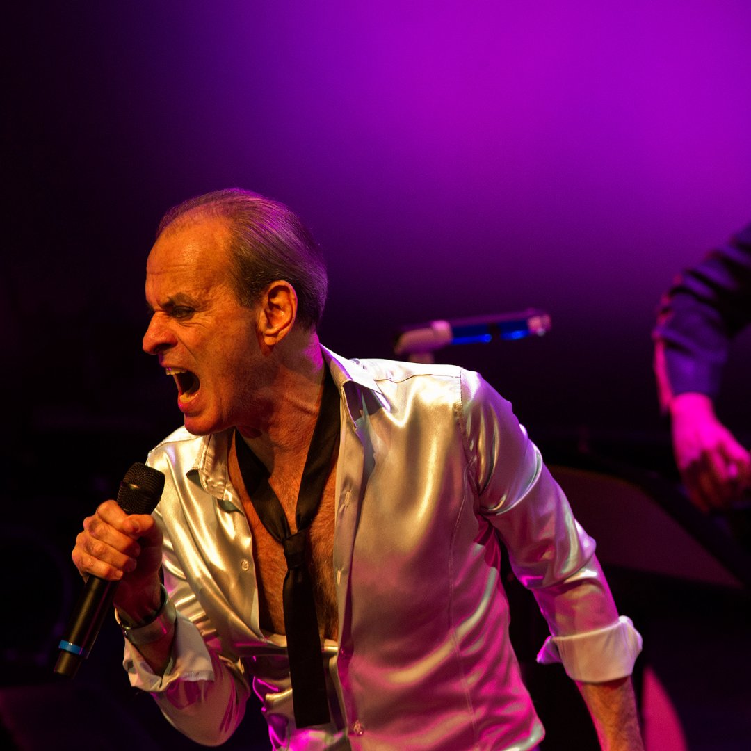 Imagem do cantor e compositor Ney Matogrosso cantando em um show