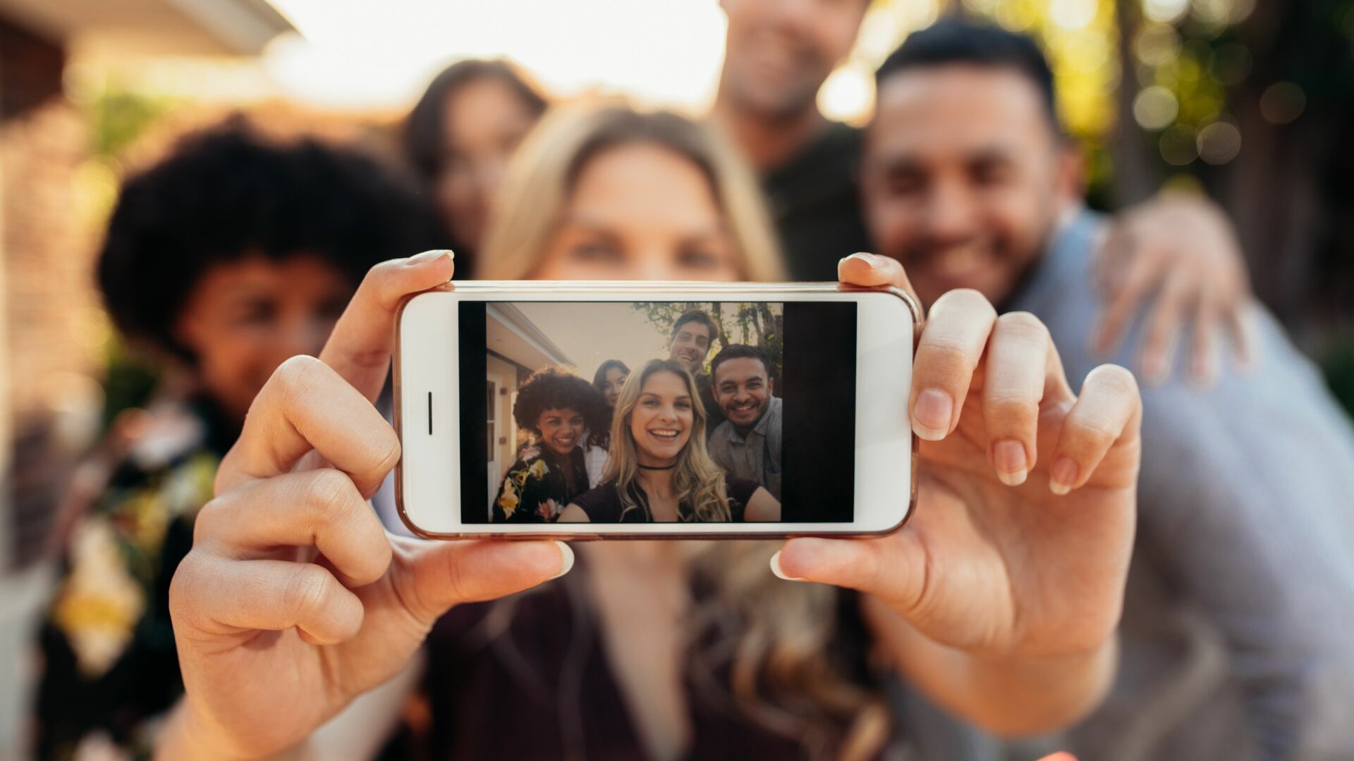Jacob Lund / Canva Amigos tirando uma foto juntos
