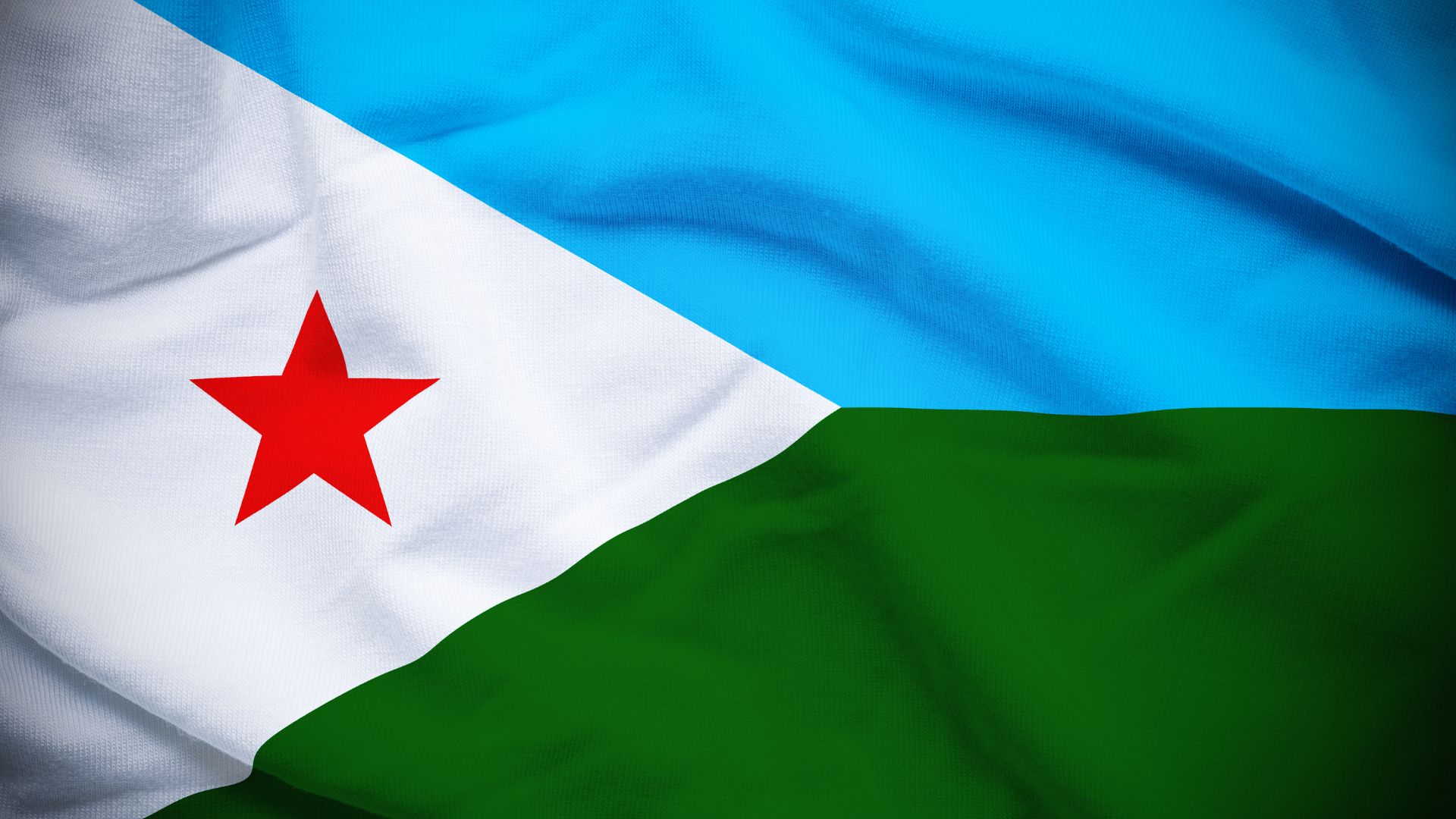 A bandeira contém duas listas horizontais nas cores de azul e verde, com um triângulo isósceles branco, com uma estrela vermelha de cinco pontas no centro.