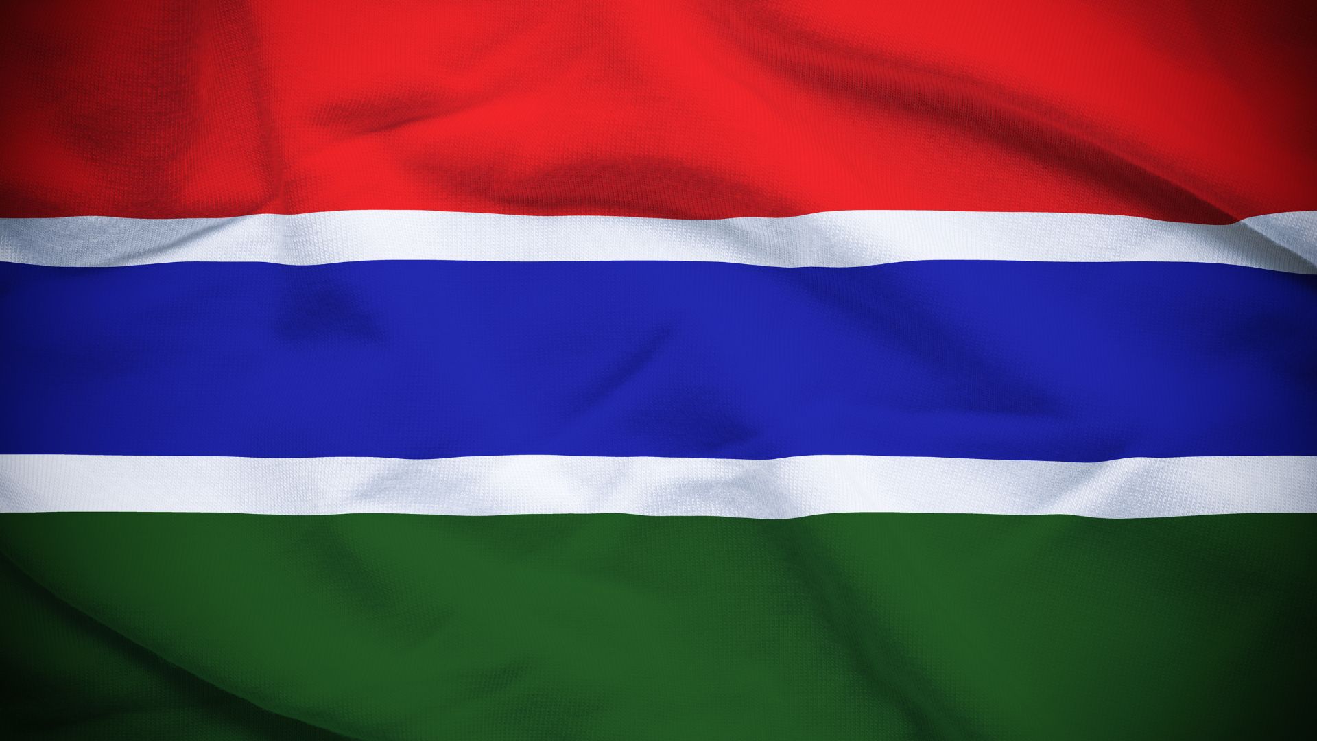 A bandeira consiste em três faixas horizontais nas cores: vermelho, azul e verde. As três faixas estão separadas por duas faixas menores, na cor branca.