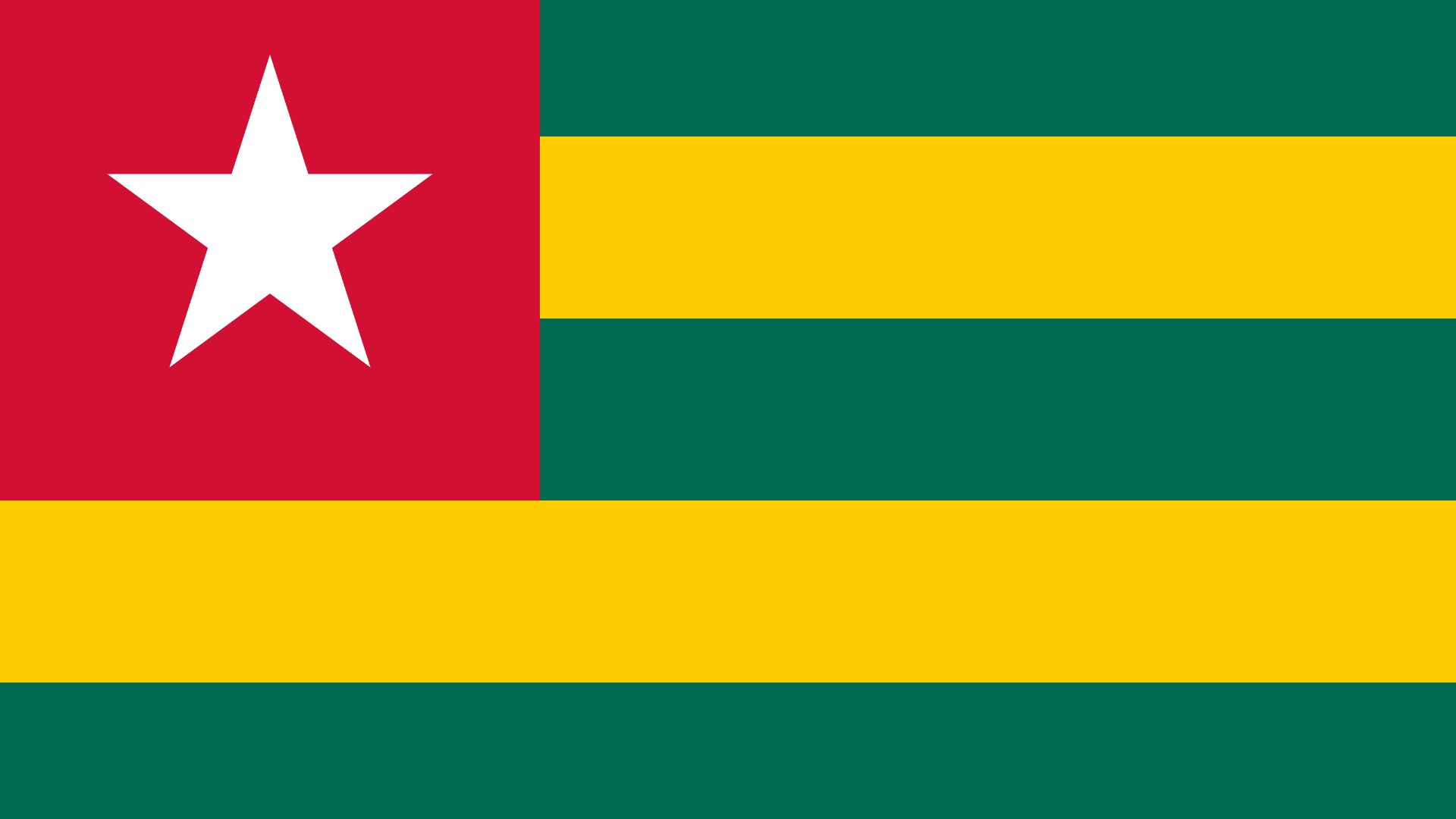 A bandeira do Togo possui as cores verde, amarelo e vermelho. Do lado esquerdo da tela, temos um quadrado vermelho com uma estrela branca no centro.