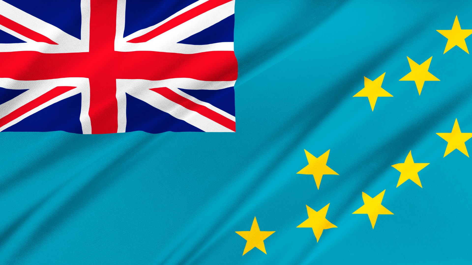 A bandeira de Tuvalu possui uma cor azul clara e a Union Jack no canto superior esquerdo. A bandeira também possui 9 estrelas, representando cada uma das ilhas do arquipélago.