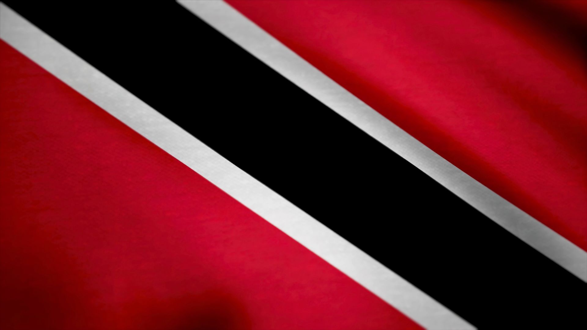 A bandeira de Trindade e Tobago. Ela possui três cores: vermelho, preto e branco.