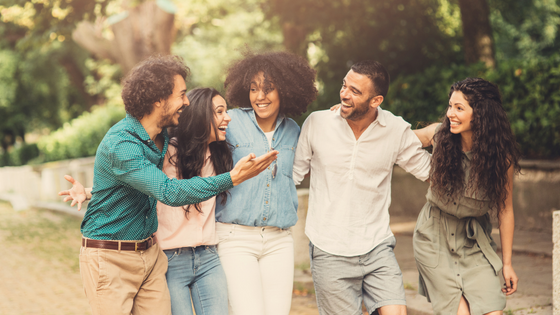 Amigos de diversas etnias sorrindo em meio a natureza