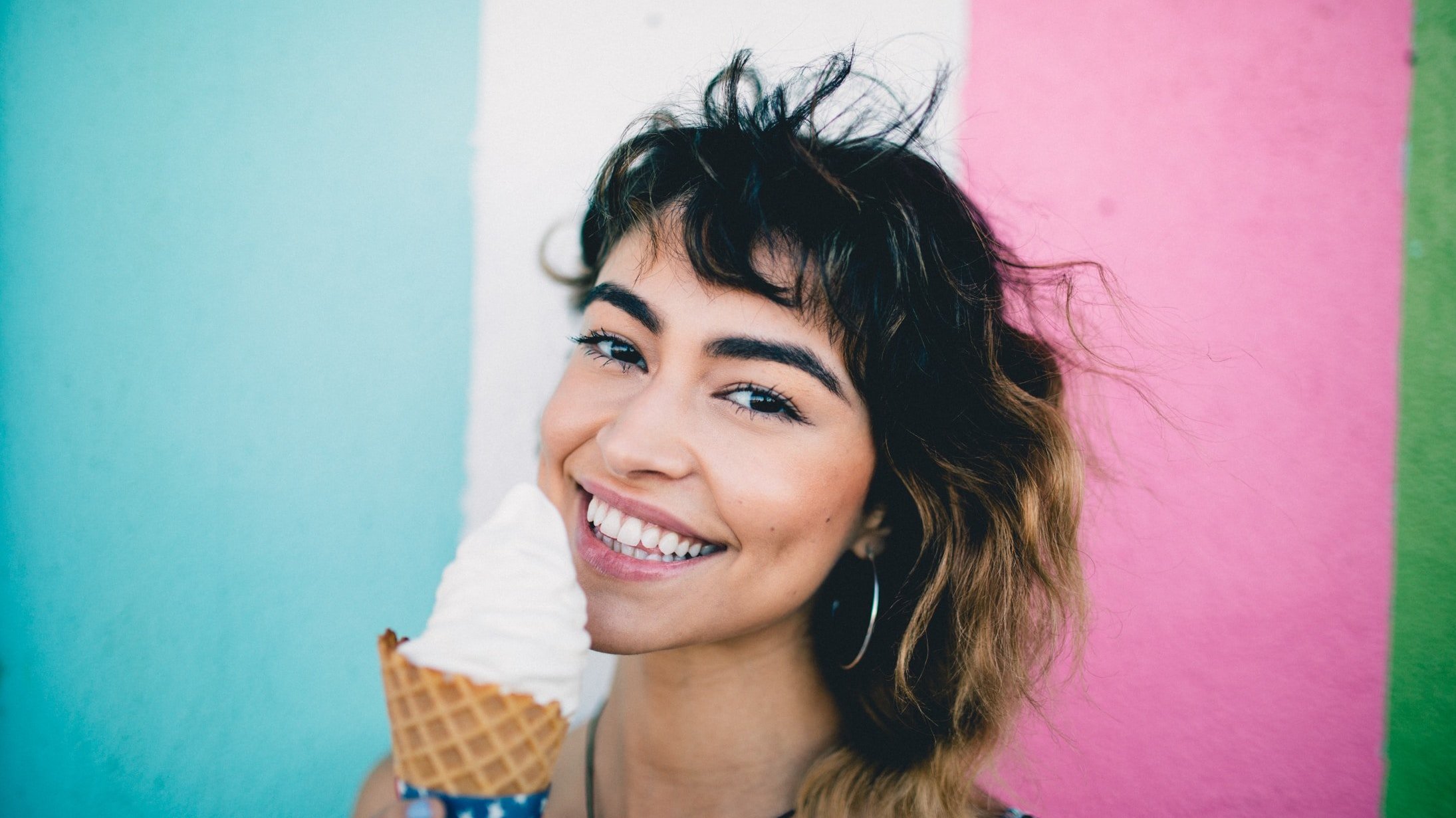 Mulher sorrindo tomando sorvete