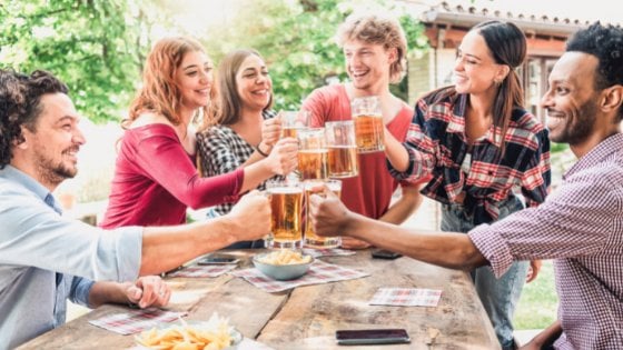 Grupo de amigos brindando com copos de chop.