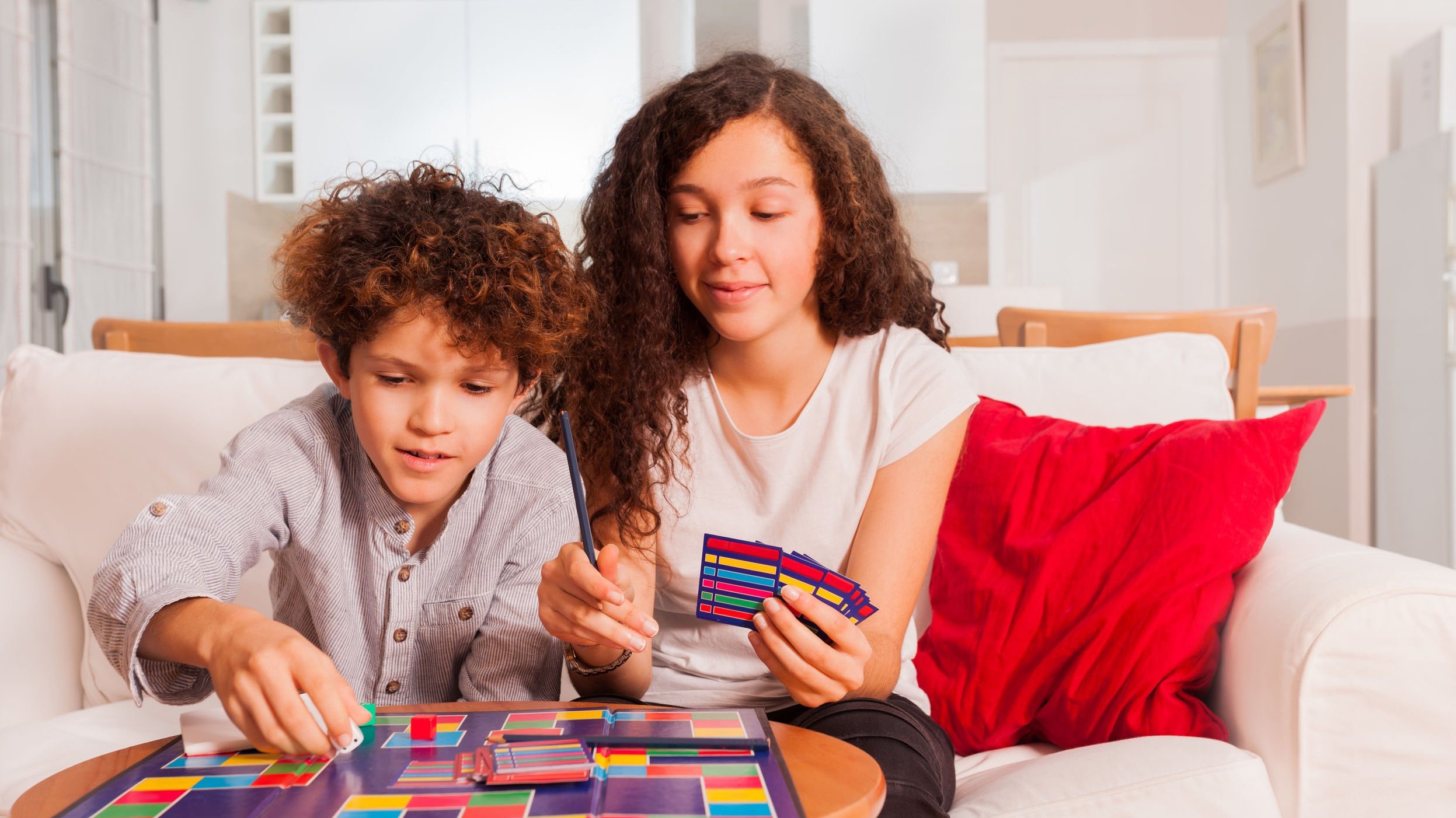 Menino e menina brancos jogando jogo de tabuleiro