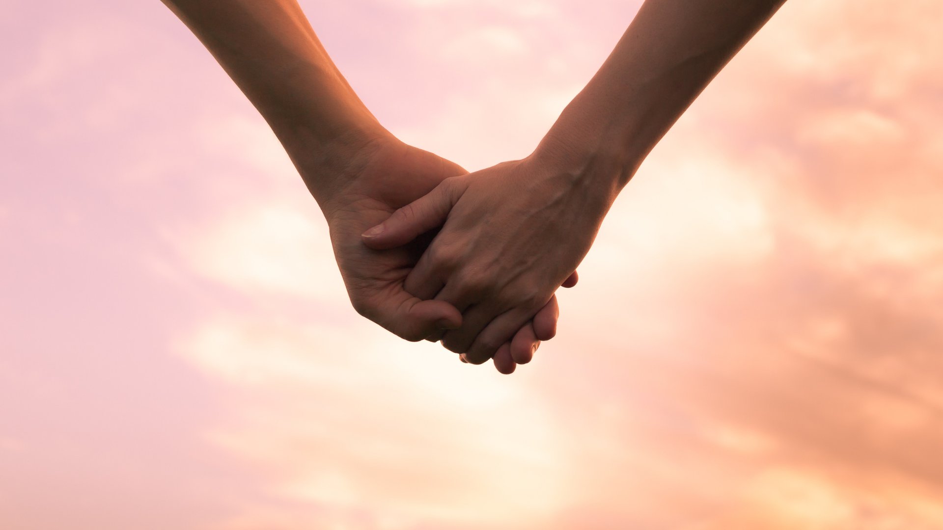 Imagem de duas pessoas com as mãos dadas