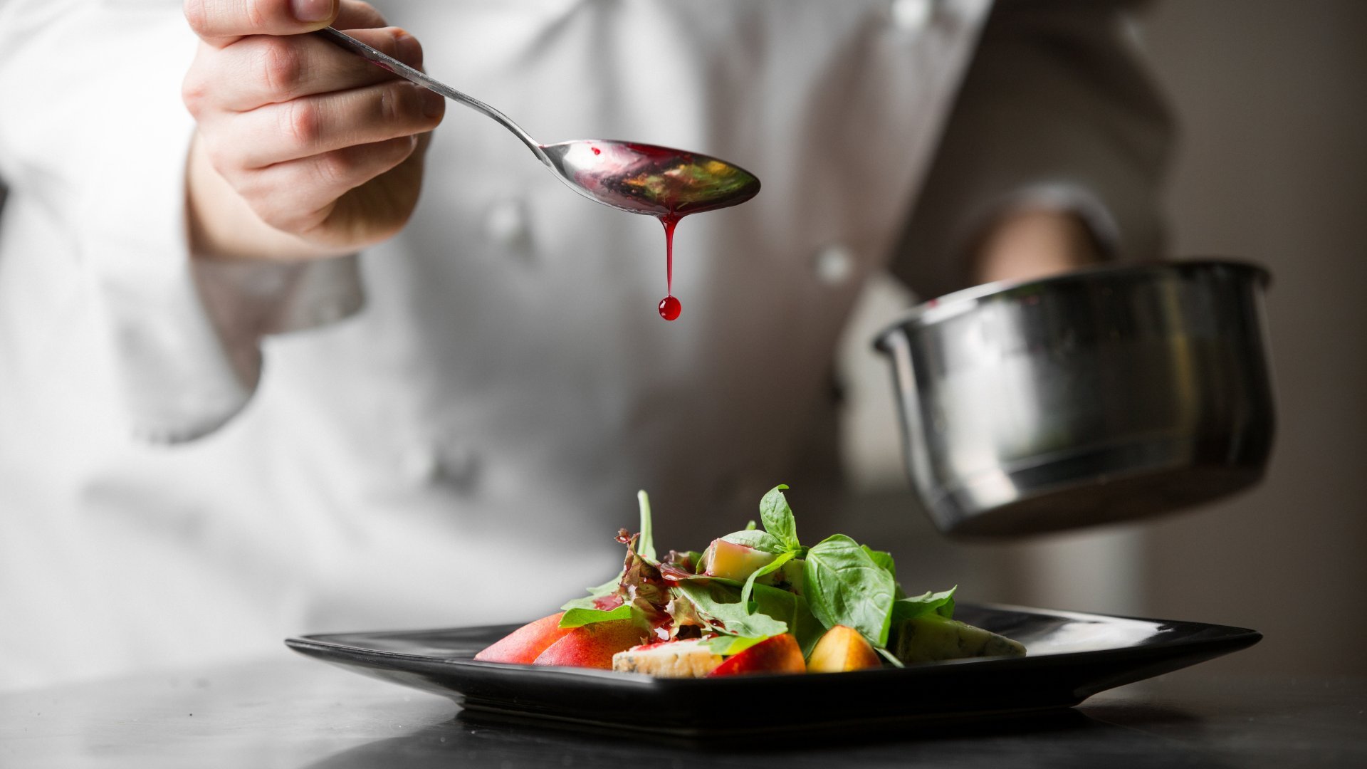 kuzminsemen / Getty Images Pro / Canva Cozinheira com uma colher terminando um prato