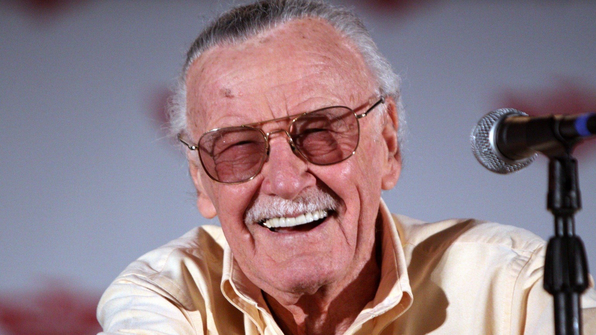 Stan Lee, de óculos, sorridente em evento público