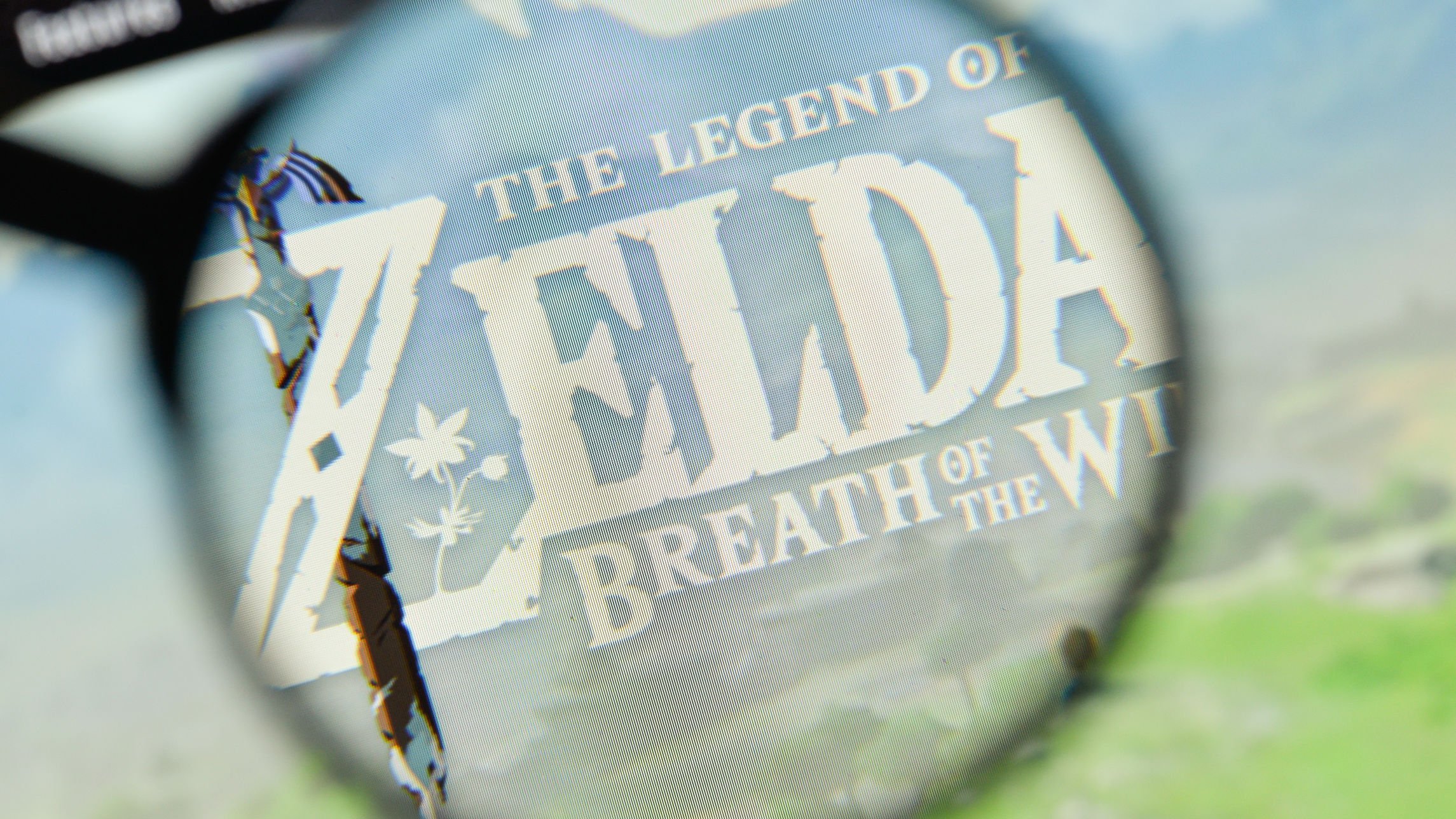 Site do jogo The Legend of Zelda, com uma lupa em cima do logo, deixando ele legível e o resto da página fora de foco.