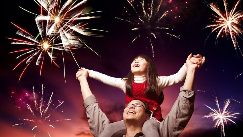 pai e filha olhando fogos de artifício no céu