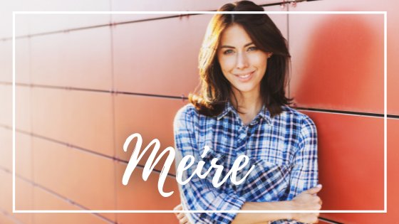 Mulher encostada no muro vermelho e sorrindo para foto com braços cruzados