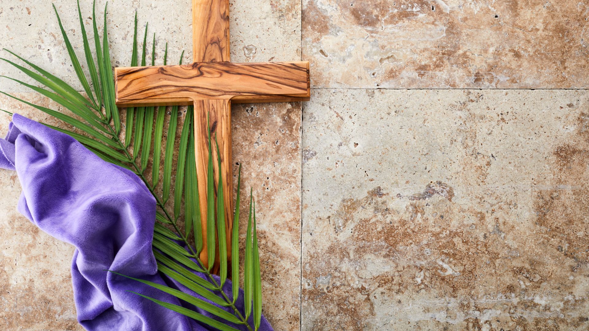 Imagem de fundo marmorizado na cor bege e em destaque, um cruz, uma ramo e uma toalha de veludo roxa, simbolizando a sexta-feira santa.